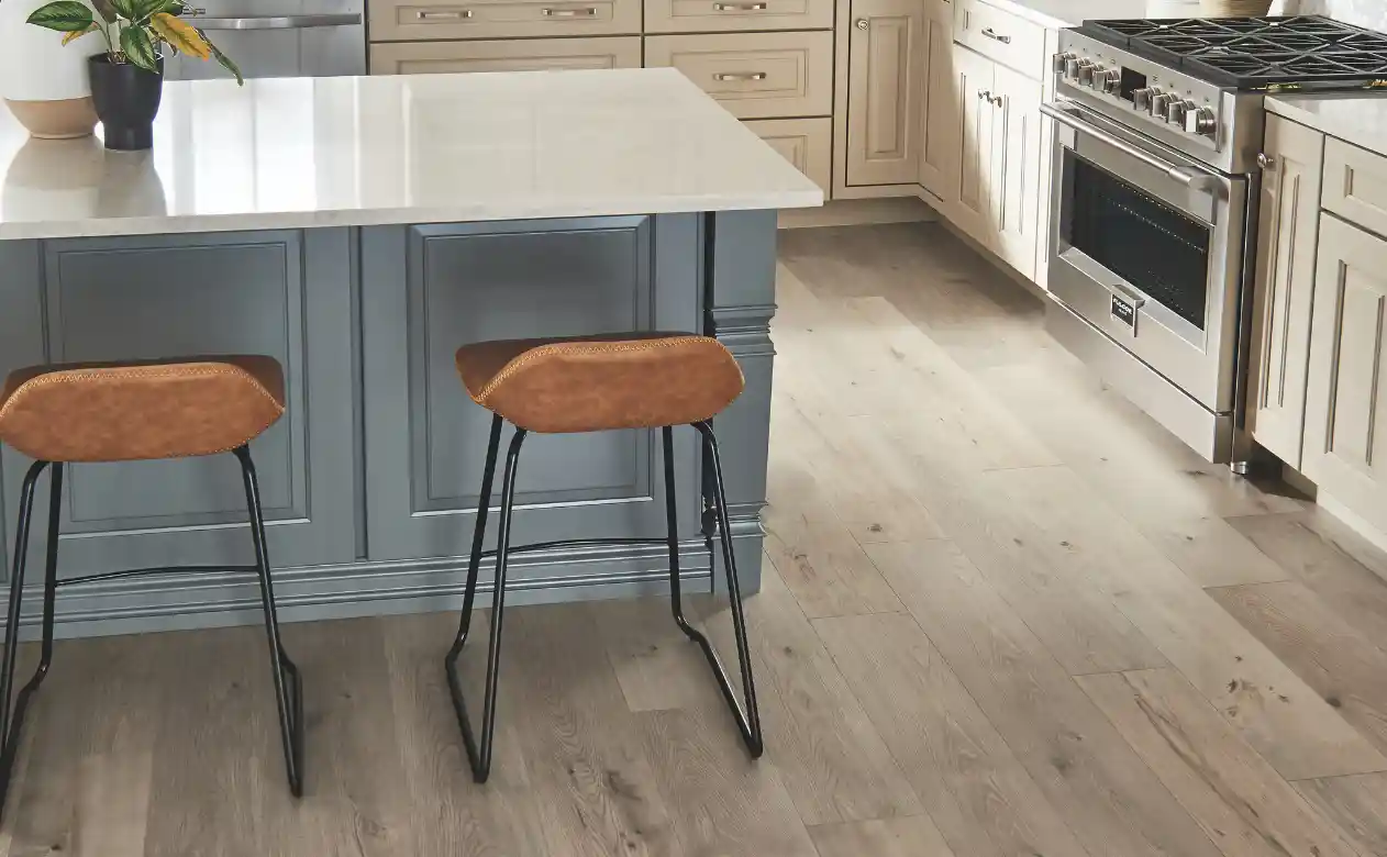 Laminate flooring in a kitchen with an island and barstools