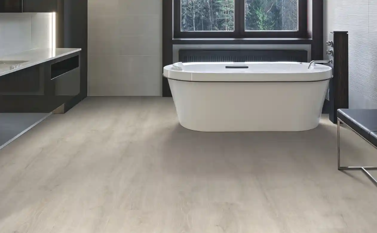 Bathroom with light wood-look laminate floors and a bathtub