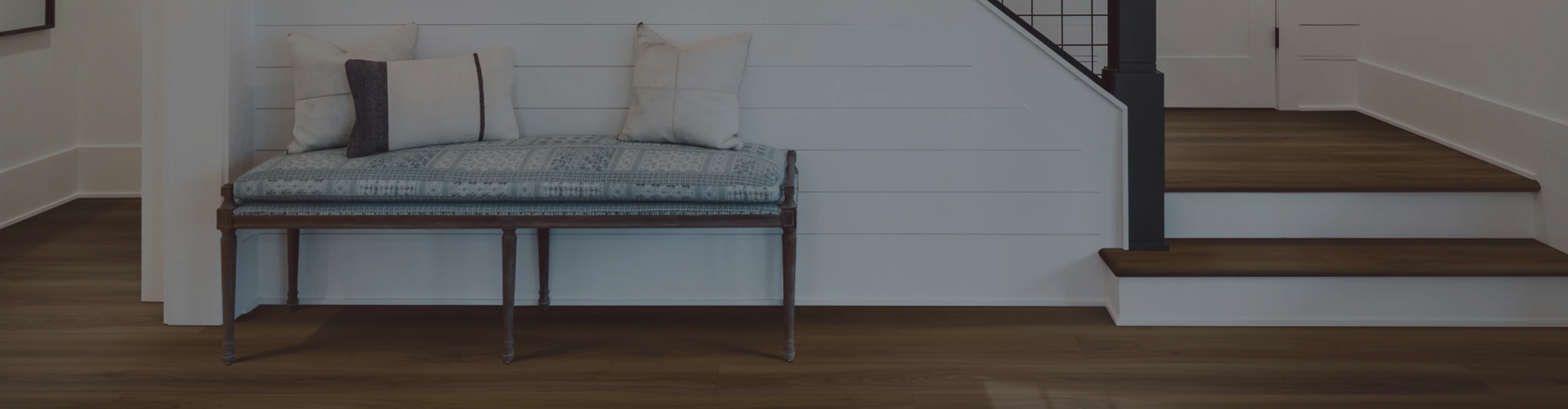 Foyer with hardwood flooring and bench